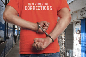 inmate in handcuffs at prison