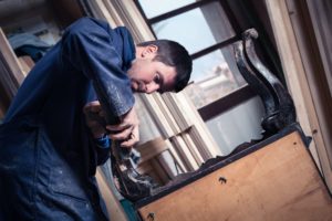 man working on furniture at job