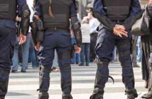 swat team standing against crowd