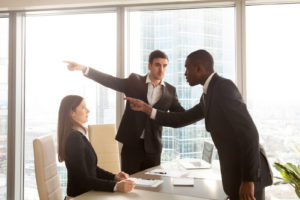 woman being harassed by men at her job