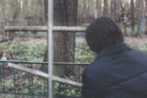man at graveyard worrying about wrongful death lawsuit