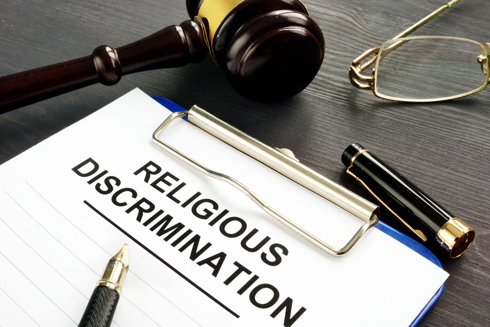 What is the burden of proof in a religious discrimination lawsuit