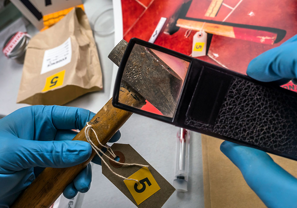 police technician examining evidence