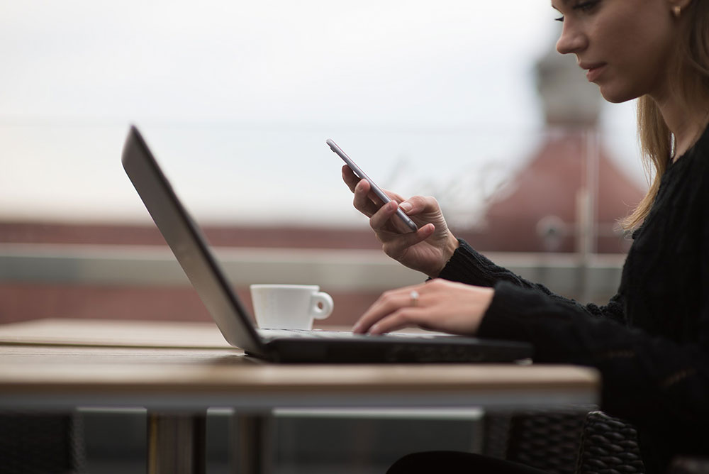 woman on phone thinking about being a whistleblower