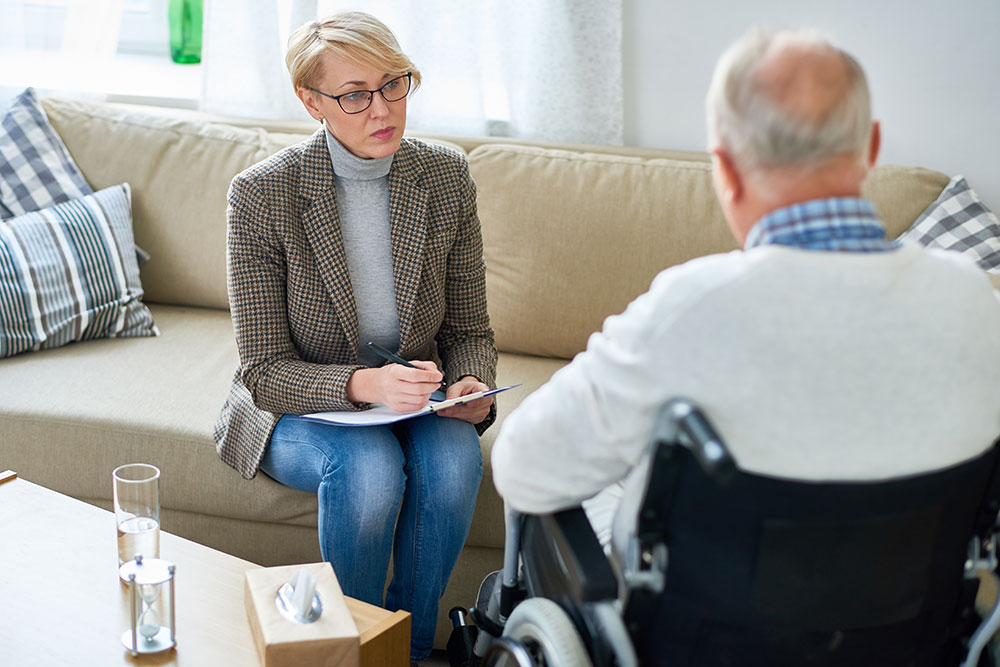 man in wheelchair working with woman, medical indifference