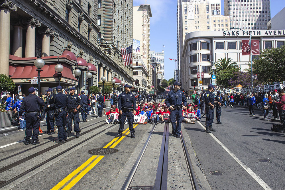 police hold back group of protesters on street, police accountability at protests