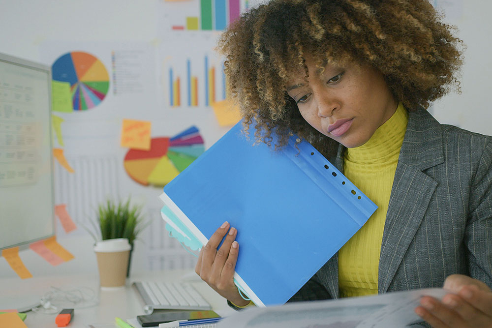 woman reading through personnel files