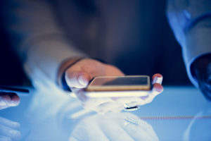 hand holding phone, recording conversations
